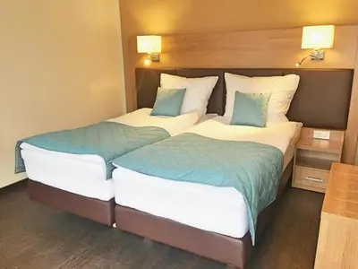 Ein Bett oder Betten in einem Zimmer der Unterkunft Sporthotel Dorum