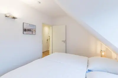 Ein Bett oder Betten in einem Zimmer der Unterkunft Fischerhus - Wohnung 8