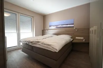 Ein Bett oder Betten in einem Zimmer der Unterkunft Wohnung 11 im Palais am Meer II