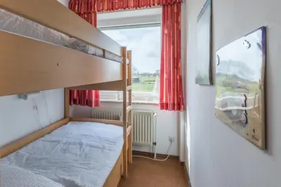 Ein Bett oder Betten in einem Zimmer der Unterkunft Vogelsand 321