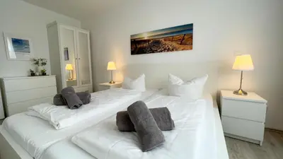 Ein Bett oder Betten in einem Zimmer der Unterkunft Ferienwohnung Nordseebrandung B4.1