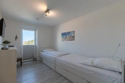 Ein Bett oder Betten in einem Zimmer der Unterkunft Quartier Hohe Geest - Wohnung Meerzeit
