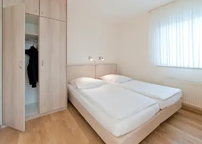 Ein Bett oder Betten in einem Zimmer der Unterkunft Haus Seemuschel - Fewo 6