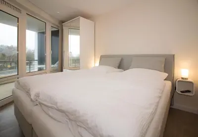 Ein Bett oder Betten in einem Zimmer der Unterkunft Kurpark-Residenz W112