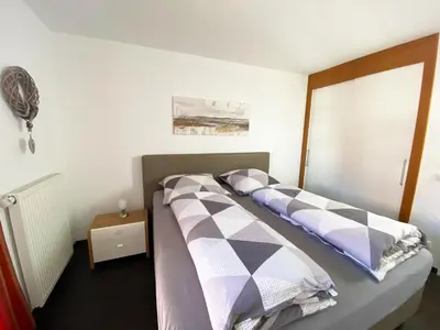 Ein Bett oder Betten in einem Zimmer der Unterkunft Ferienwohnungen Residenz Hohe Lith - Duhnen