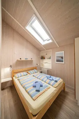 Ein Bett oder Betten in einem Zimmer der Unterkunft Ferienhaus Nordseeparadies