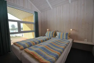 Ein Bett oder Betten in einem Zimmer der Unterkunft Ferienhaus Hus am See