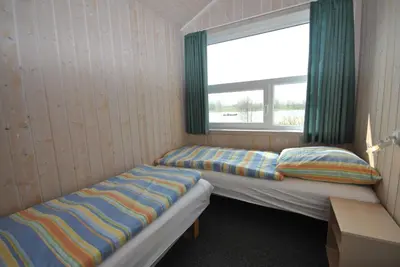Ein Bett oder Betten in einem Zimmer der Unterkunft Ferienhaus Hus am See