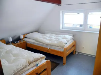 Ein Bett oder Betten in einem Zimmer der Unterkunft Ferienhaus Krabbe Friedrichskoog, 8 Personen, 3 bzw 4 Schlafzimmer