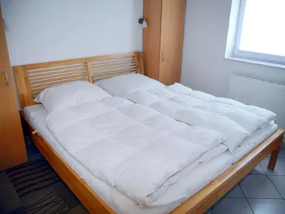 Ein Bett oder Betten in einem Zimmer der Unterkunft Ferienhaus Krabbe Friedrichskoog, 8 Personen, 3 bzw 4 Schlafzimmer