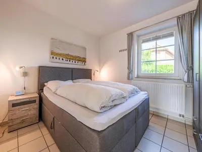 Ein Bett oder Betten in einem Zimmer der Unterkunft Ferienwohnung im EG in Friedrichskoog-Spitze