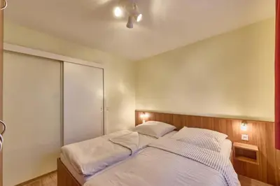 Ein Bett oder Betten in einem Zimmer der Unterkunft Dünenglück, Ferienwohnung 12