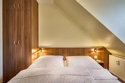 Ein Bett oder Betten in einem Zimmer der Unterkunft Dünenglück, Ferienwohnung 33