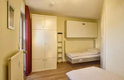 Ein Bett oder Betten in einem Zimmer der Unterkunft Dünenglück, Ferienwohnung 13