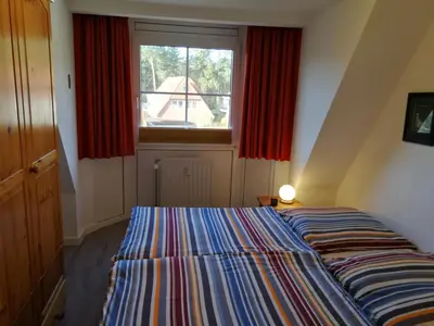 Ein Bett oder Betten in einem Zimmer der Unterkunft Scharhörn, Ferienwohnung 14