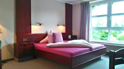 Ein Bett oder Betten in einem Zimmer der Unterkunft Hotel am Hasengarten