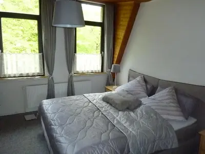 Ein Bett oder Betten in einem Zimmer der Unterkunft Ehemaliges Waldkurhaus Drangstedt
