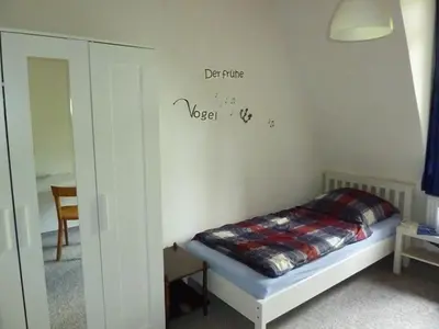 Ein Bett oder Betten in einem Zimmer der Unterkunft Ehemaliges Waldkurhaus Drangstedt