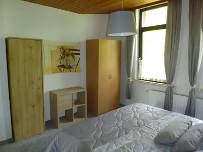 Ein Bett oder Betten in einem Zimmer der Unterkunft Ehemaliges Waldkurhaus Drangstedt