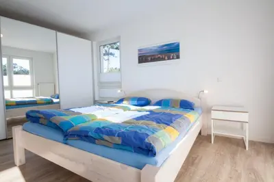 Ein Bett oder Betten in einem Zimmer der Unterkunft Dünenblick