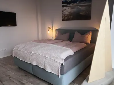 Ein Bett oder Betten in einem Zimmer der Unterkunft Ferienwohnung für große Familien im Haus Akunak
