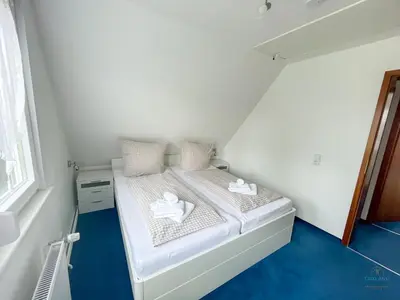 Ein Bett oder Betten in einem Zimmer der Unterkunft Ferienhaus Am Ringwall 109