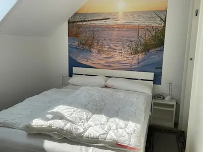 Ein Bett oder Betten in einem Zimmer der Unterkunft Gleich hinterm Deich 4