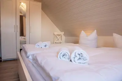 Ein Bett oder Betten in einem Zimmer der Unterkunft Ferienwohnung 'Haus Ingeborg, Wohnung 1/EG'