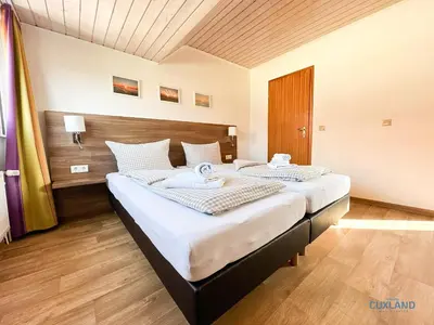 Ein Bett oder Betten in einem Zimmer der Unterkunft Familienurlaub auf zwei Ebenen im Herzen von Duhnen