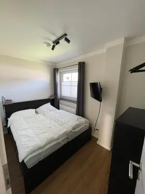 Ein Bett oder Betten in einem Zimmer der Unterkunft Dyke