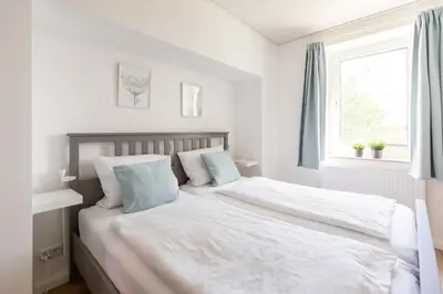 Ein Bett oder Betten in einem Zimmer der Unterkunft Nordseehof Brömmer