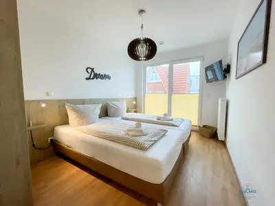 Ein Bett oder Betten in einem Zimmer der Unterkunft Haus Windjammer Duhnen Wohnung 15