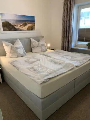 Ein Bett oder Betten in einem Zimmer der Unterkunft Strandresidenz 108