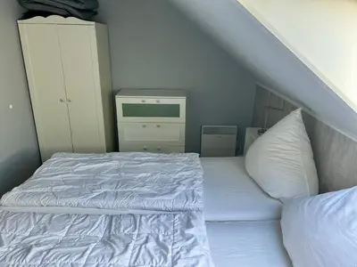 Ein Bett oder Betten in einem Zimmer der Unterkunft Friesenhof