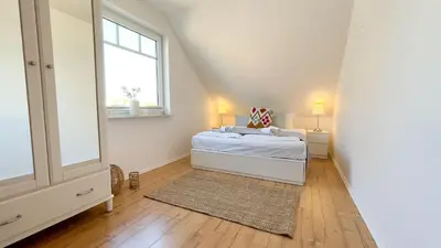 Ein Bett oder Betten in einem Zimmer der Unterkunft Haus Eversand 2