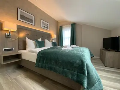 Ein Bett oder Betten in einem Zimmer der Unterkunft Mertinkus Nordseehotel