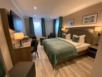 Ein Bett oder Betten in einem Zimmer der Unterkunft Mertinkus Nordseehotel