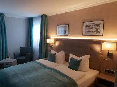 Ein Bett oder Betten in einem Zimmer der Unterkunft Mertinkus Nordseehotel