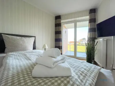 Ein Bett oder Betten in einem Zimmer der Unterkunft Strandpalais Duhnen Wohnung 3