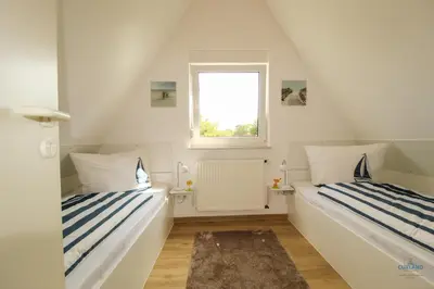 Ein Bett oder Betten in einem Zimmer der Unterkunft Ferienhaus Kampweg 15