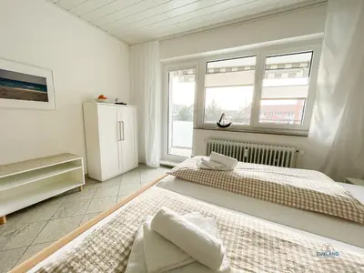 Ein Bett oder Betten in einem Zimmer der Unterkunft Strandappartement 15 Haus Kehrwieder