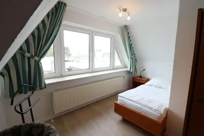 Ein Bett oder Betten in einem Zimmer der Unterkunft Haus Itjen Grün 1