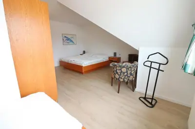 Ein Bett oder Betten in einem Zimmer der Unterkunft Haus Itjen Grün 1