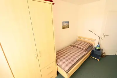 Ein Bett oder Betten in einem Zimmer der Unterkunft Nordseebrandung B3.5