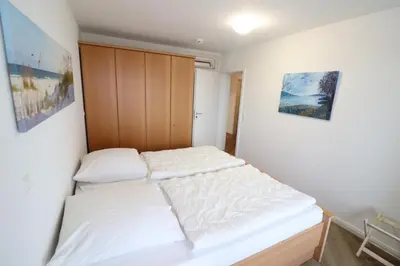Ein Bett oder Betten in einem Zimmer der Unterkunft Nordseebrandung D5.2