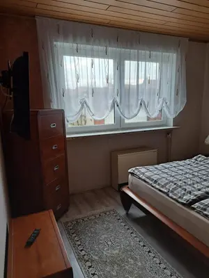 Ein Bett oder Betten in einem Zimmer der Unterkunft Ferienwohnung Lefering Stiftung