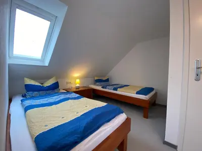 Ein Bett oder Betten in einem Zimmer der Unterkunft Duhner Brise, Ferienwohnung 5