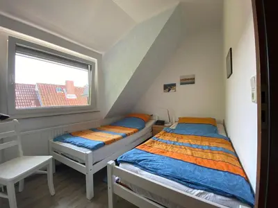 Ein Bett oder Betten in einem Zimmer der Unterkunft Haus Zyrus, Ferienwohnung 10