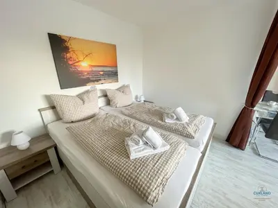 Ein Bett oder Betten in einem Zimmer der Unterkunft Haus Elbe Döse Wohnung 9