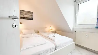 Ein Bett oder Betten in einem Zimmer der Unterkunft strandnahe Ferienwohnung mit zwei sep. Schlafzimmern